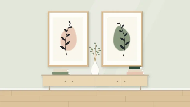 Two framed paintings side by side, each with a soft rounded color shape behind a dark line stem with leaves