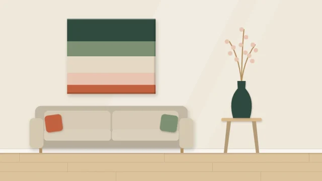 Wall artwork of five horizontal color bands beside a cushion and a vase that repeat the same colors