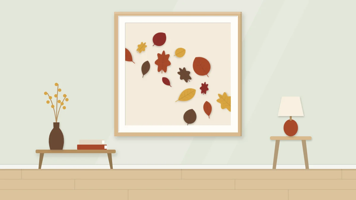 A framed artwork with paper leaves in rust, ochre, deep red and brown drifting diagonally across a cream background