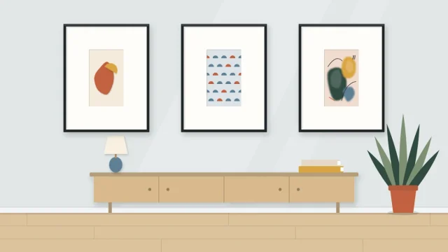 Three matching thin frames in a row, each with a small handmade piece centered in a wide mat