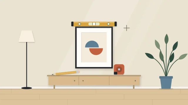 A small framed piece on a wall with a level resting on top of the frame and a pencil mark beside it