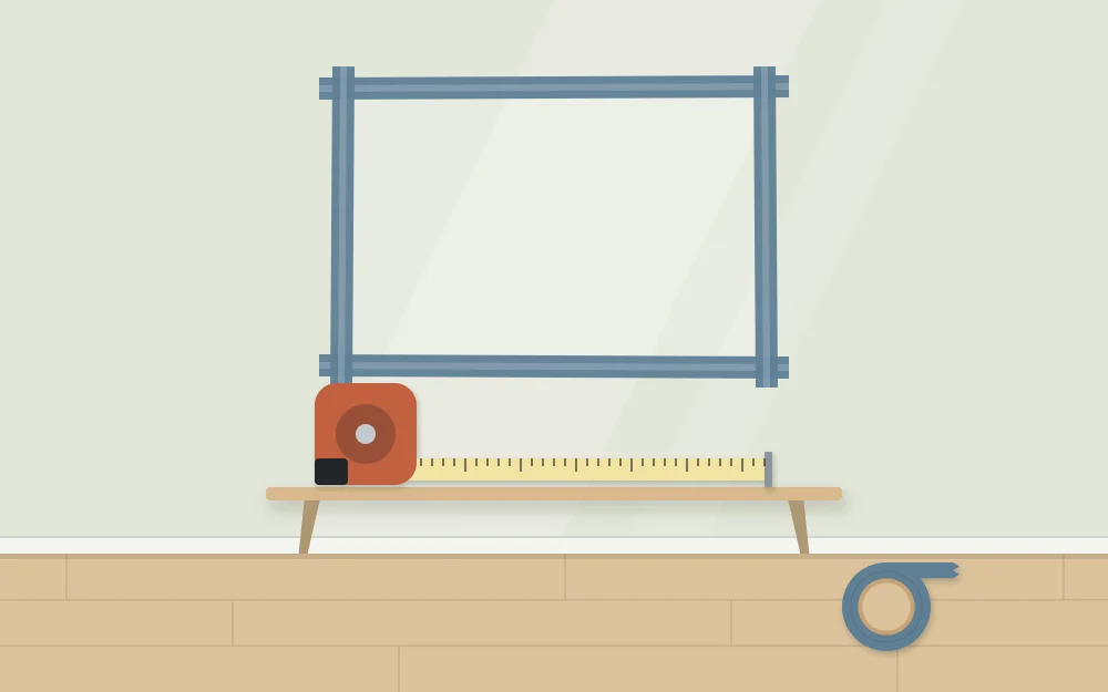 A wall with a rectangle outlined in painter's tape to test a size, with a tape measure below