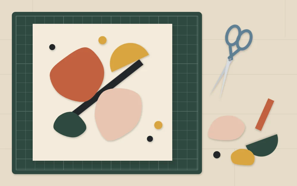 Loose cut paper shapes arranged on a sheet with scissors beside them and spare shapes set aside
